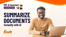 Foxit PDF AI Assistant tutorial banner with headline ‘Summarize Documents Instantly with AI’ beside a person sitting at a desk using a laptop, Foxit logo in the corner, and an illustrated fox mascot indicating it is part of a tutorial series.